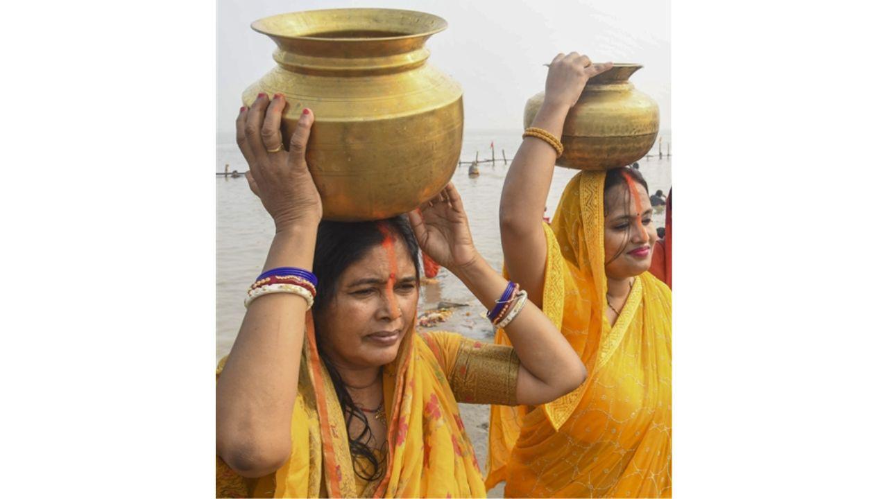 Devotees carry the holy water of River Ganga after performing the rituals of 'Nahay Khay'