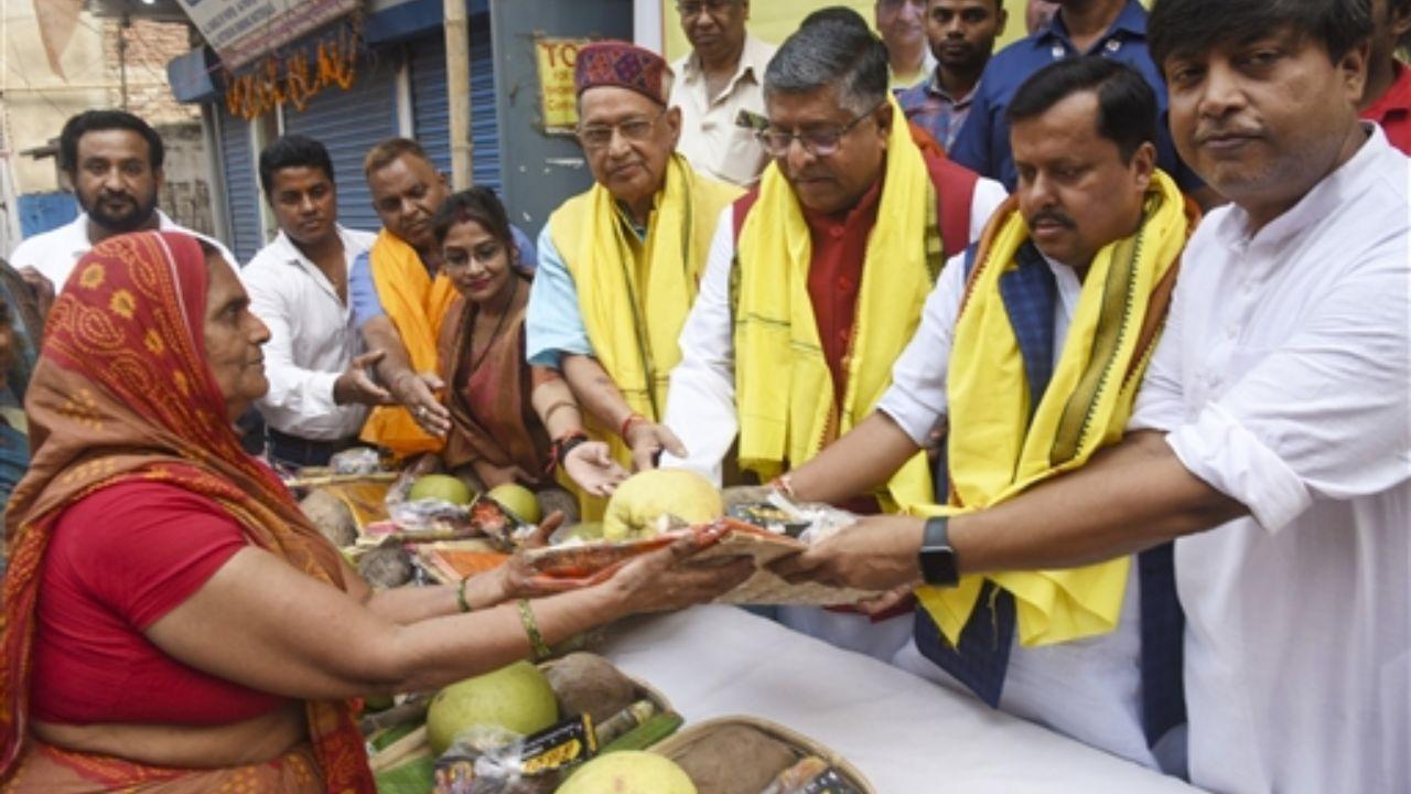 BJP MP Ravi Shankar Prasad with others distributes puja materials to women in Patna
