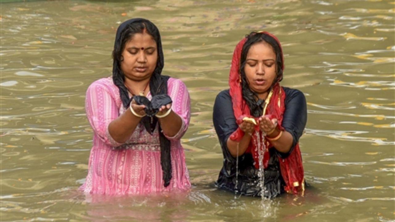 Women offer prayers while taking a dip in the Ganga river during the first day of 'Nahay Khay' ritual
