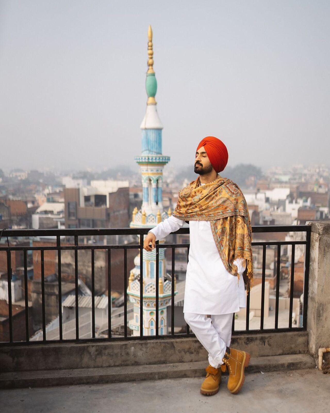 He wore a bright orange turban and posed in front of the city's backdrop.