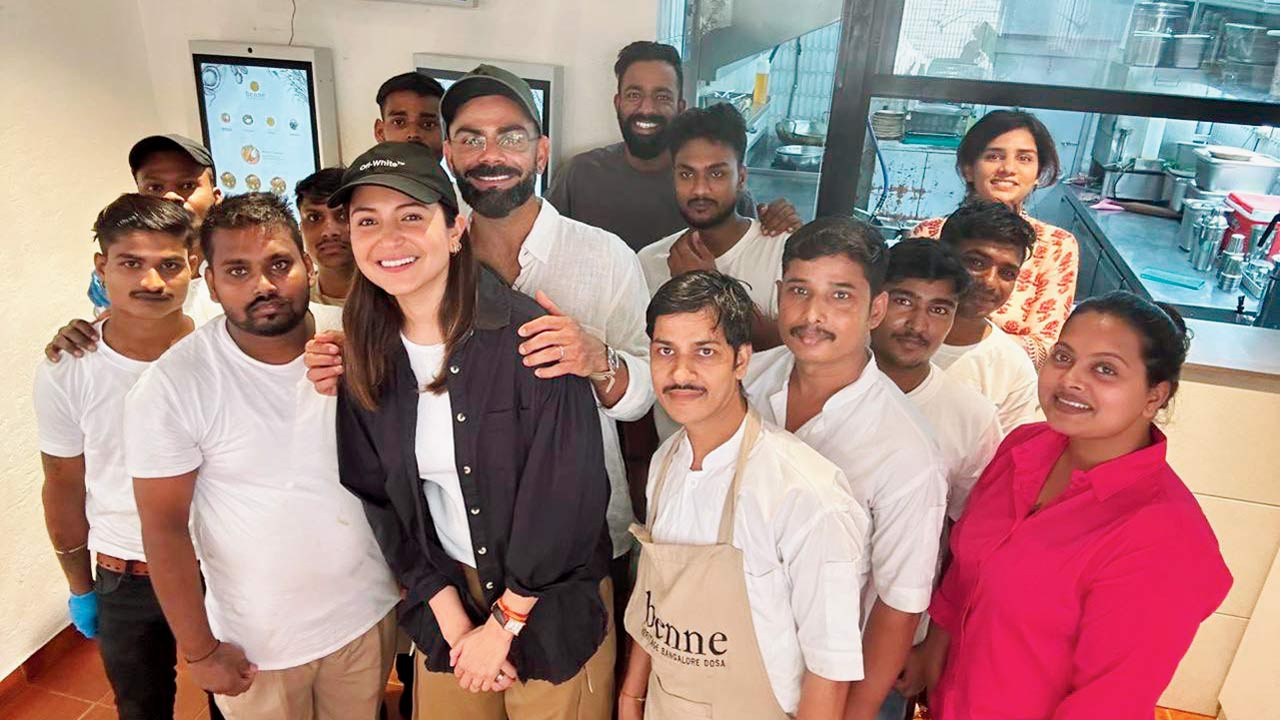 Virat Kohli and Anushka Sharma pose with the team at the Bandra eatery