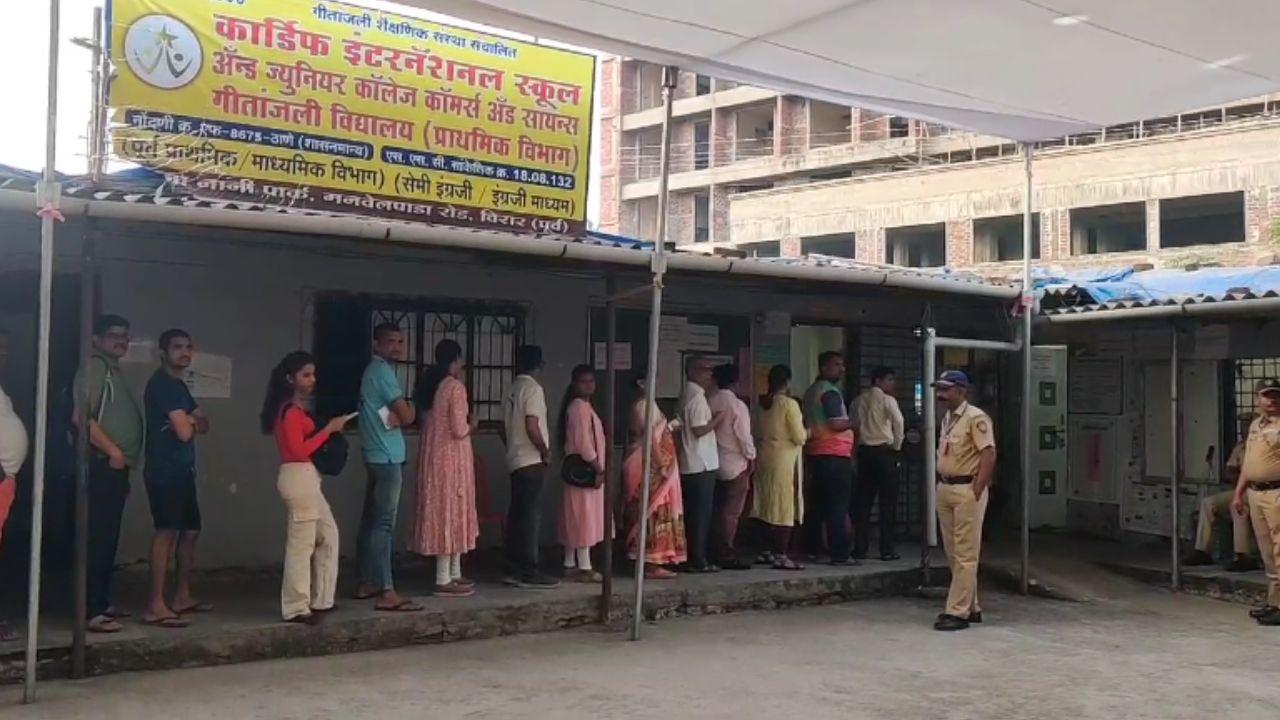 Voters are standing in a queue at a school in Virar East