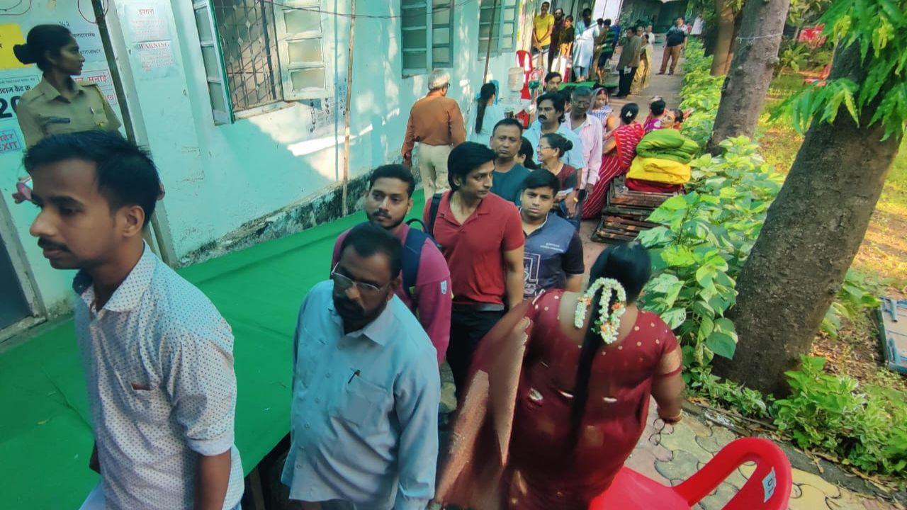Long queue of early voters outside polling station awaiting their turn to exercise their right