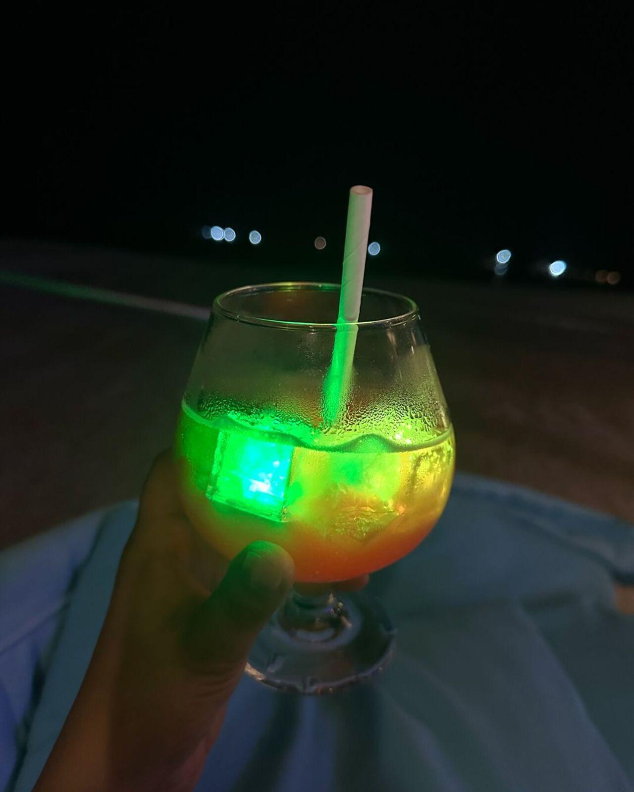 She then shared a video of herself having a glowing drink. She is seen having some neon paint that sparkles in the dark on her face