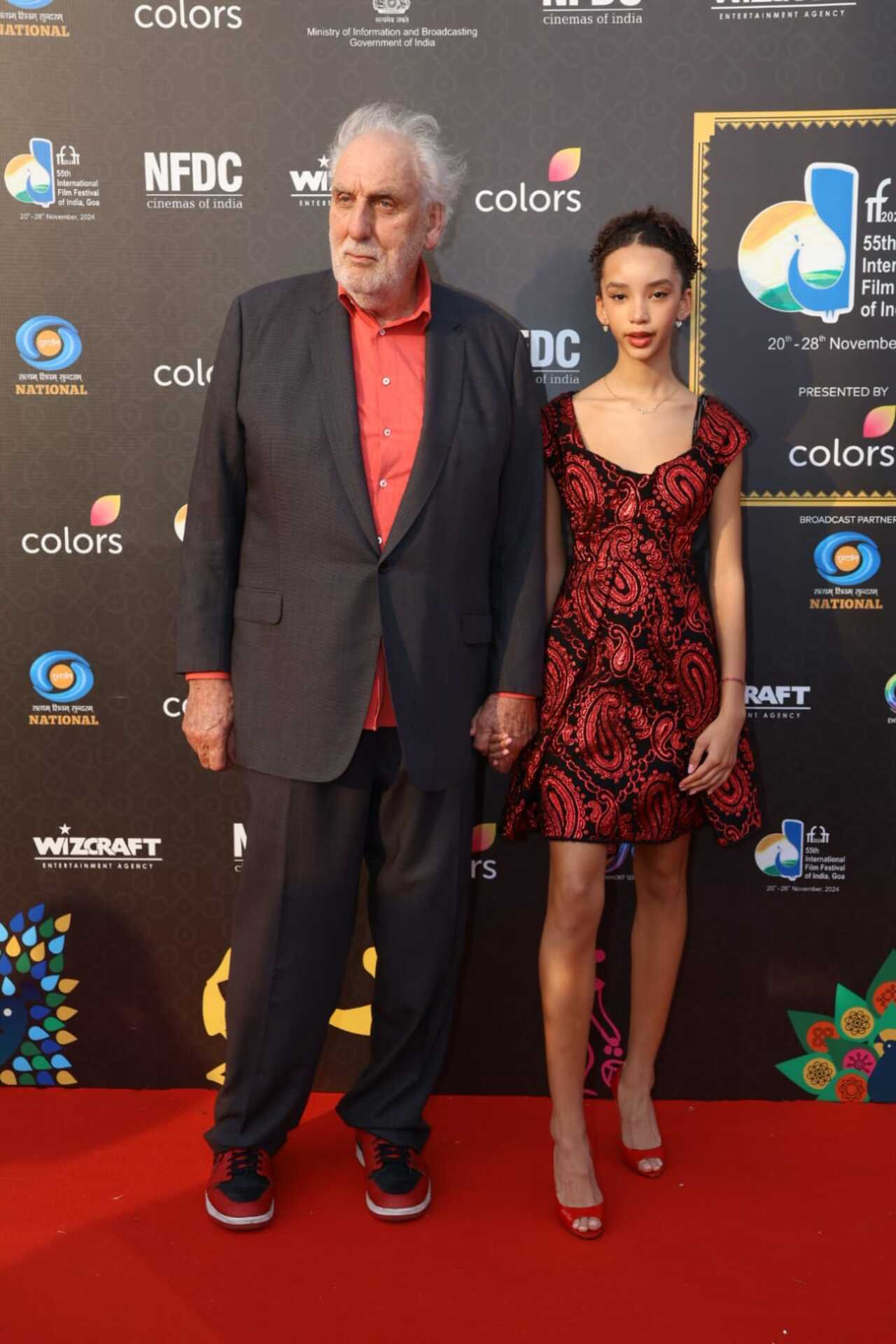 Australian filmmaker Philip Noyce poses on the red carpet with his daughter. The filmmaker will be accepting a lifetime achievement award on closing night