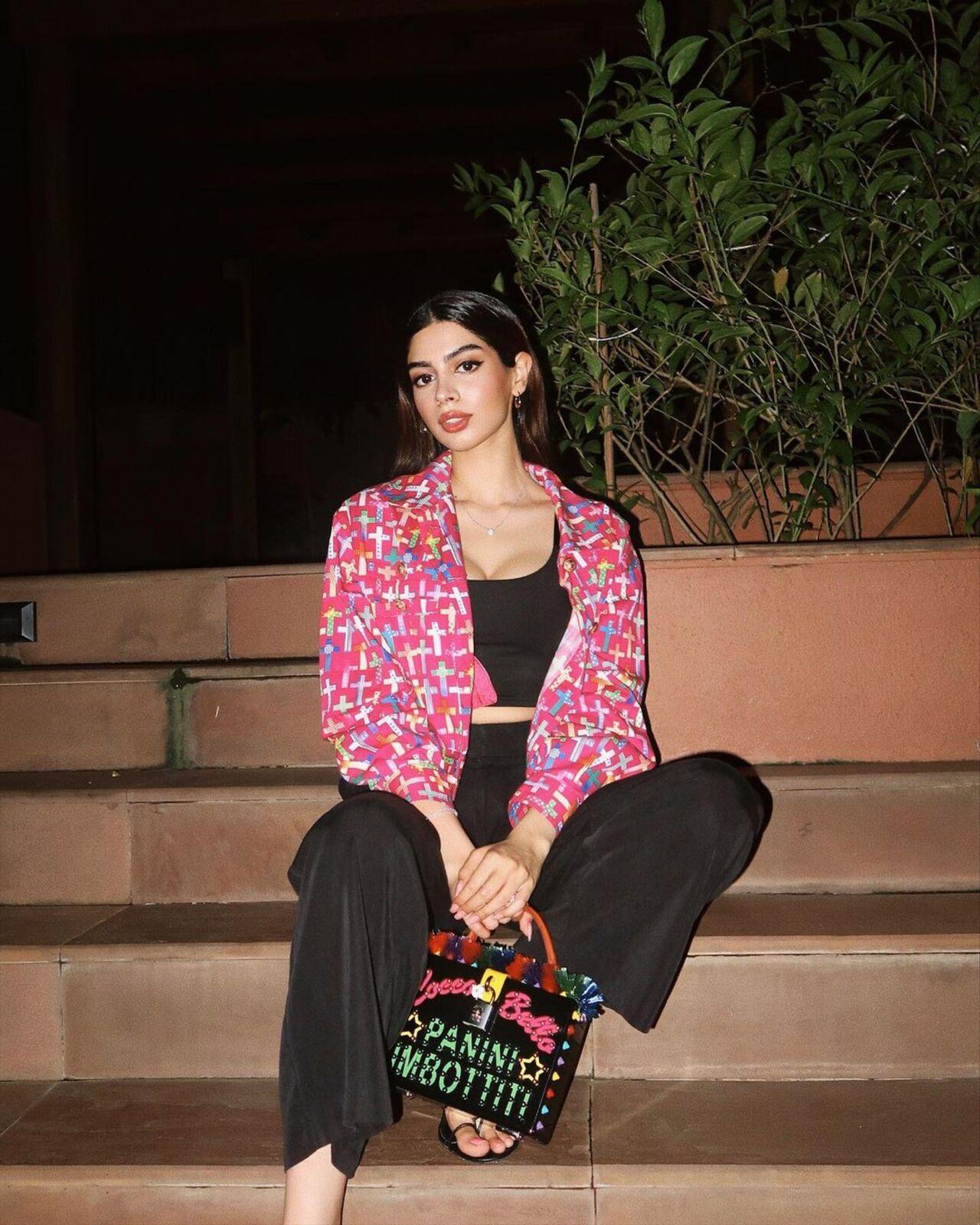 She elevates her all black look with a pop of colour which is the jacket