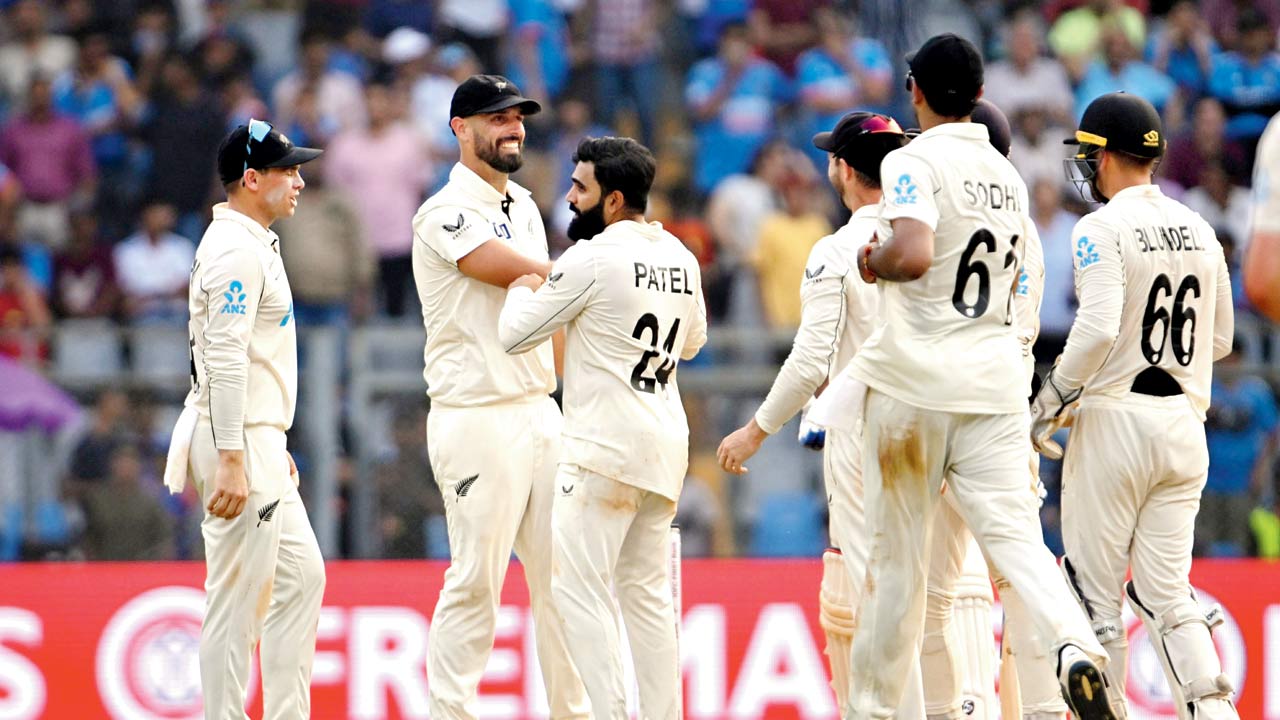 New Zealand players celebrate the wicket of Yashasvi Jaiswal yesterday