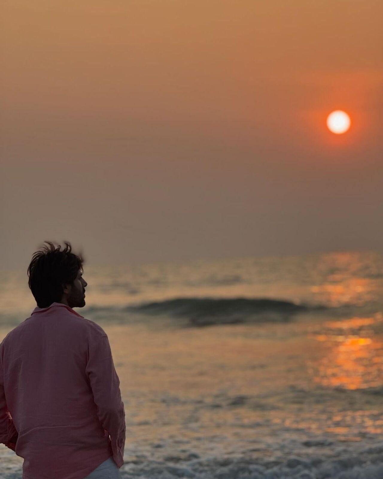 Dressed in a pink shirt and white pants, Kartik looked mesmerised by the beauty of the sea and sunset.