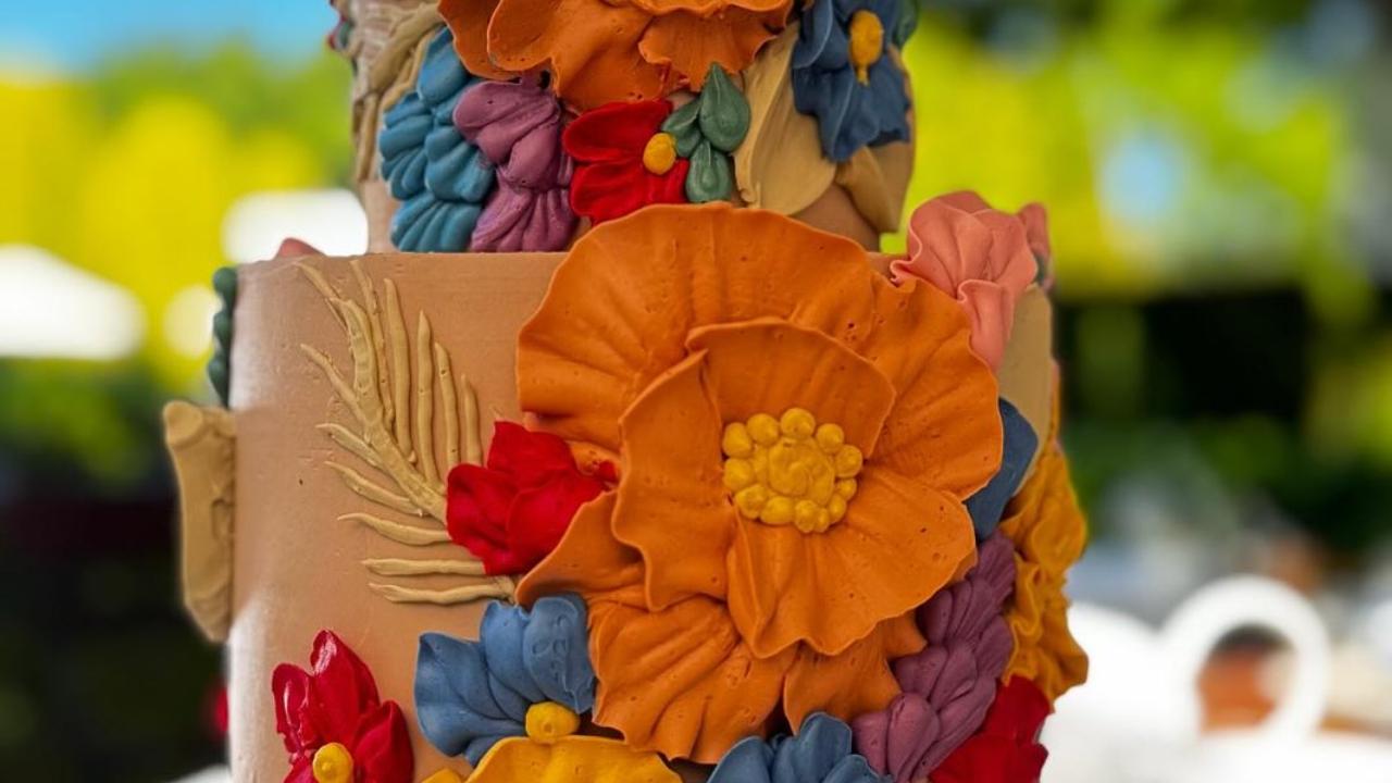 This picture gives a glimpse of the wedding cake, which features a beautiful floral pattern.