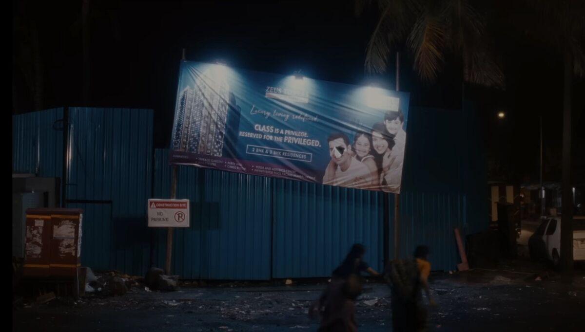 Right from local train seats to blue pre-painted galvanized iron sheets masking the city in the name of development. Blue is also the colour of illusions, giving the characters 'blues' because they are aware that they cannot access the privilege reserved for the privileged.