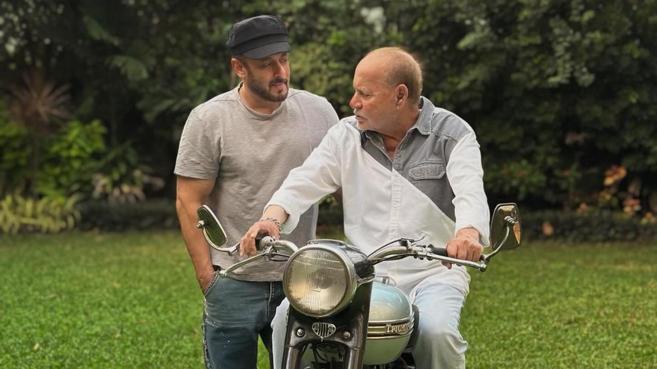 Salman Khan poses with his father Salim Khan's first bike, Triumph Tiger 100