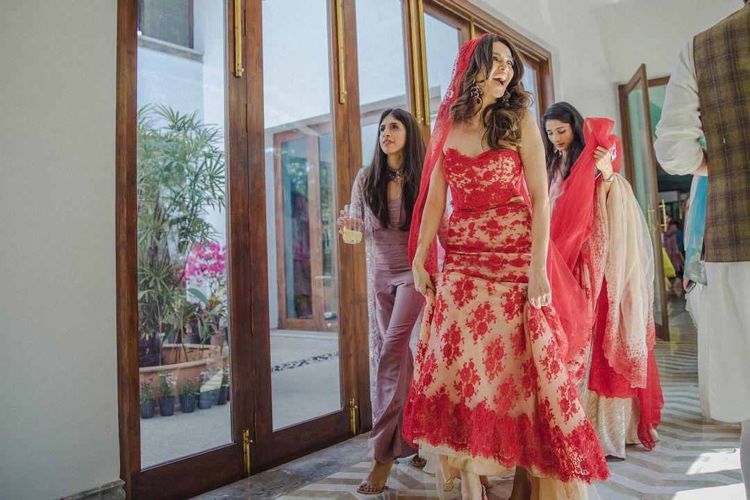 For her wedding, Shibani Dandekar turned heads in a red corset top and skirt set by Jade by Monica and Karishma, veering away from the conventional bridal lehenga with a stunning strapless design.