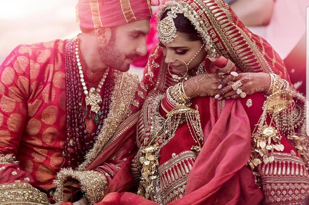 Deepika Padukone embraced tradition for her Konkani wedding, choosing a regal golden-and-red Kanjeevaram saree paired with heavy jewelry by Sabyasachi.