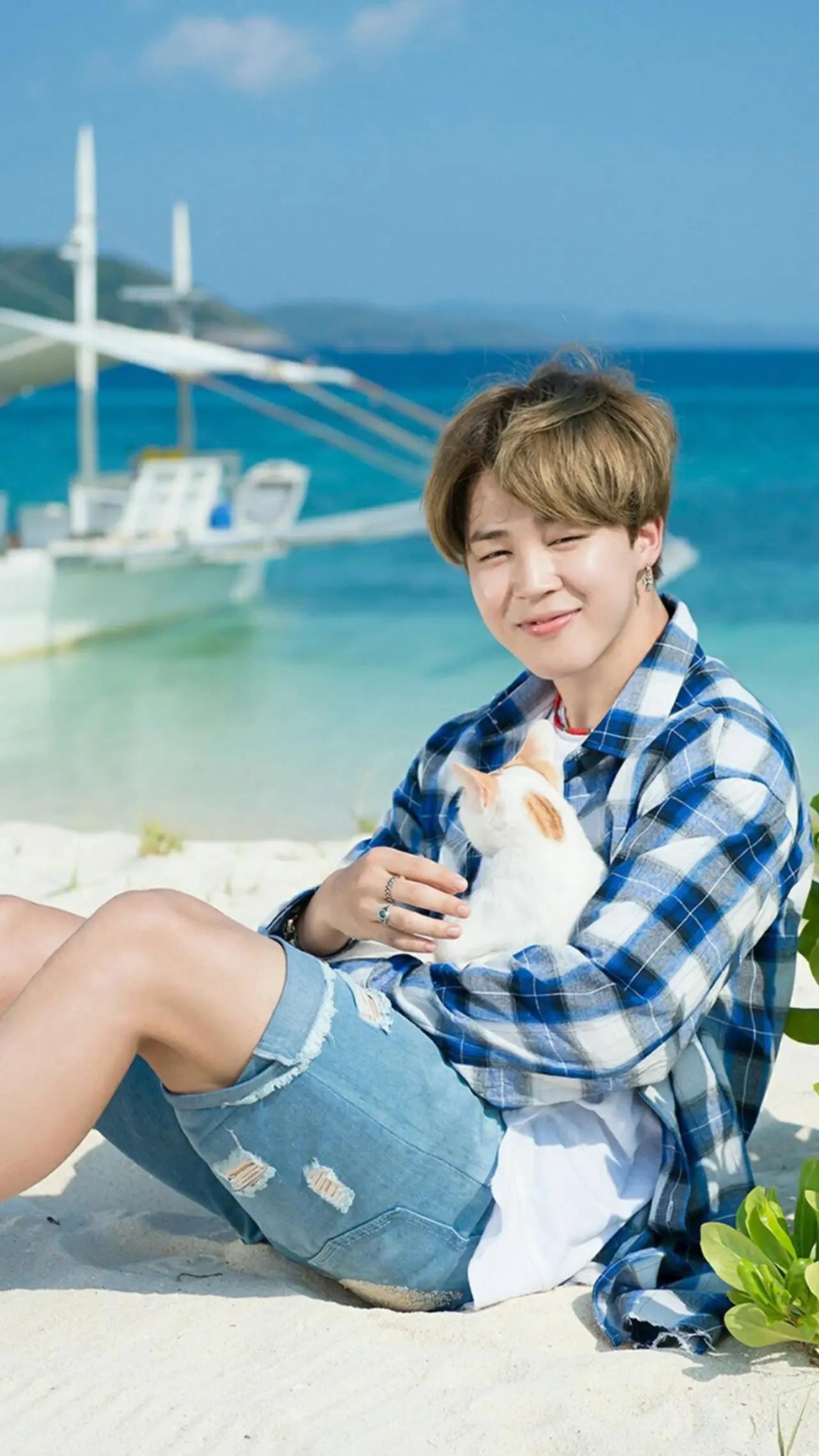 The animal-lover in Jimin sprung up during his shoot for his solo song, 'Serendipity'! We can't tell who looks more adorable - the fluffy, calico cat or Jimin with his blue-themed flannel shirt and shorts. His outfit perfectly matched the light-hearted energy of the song