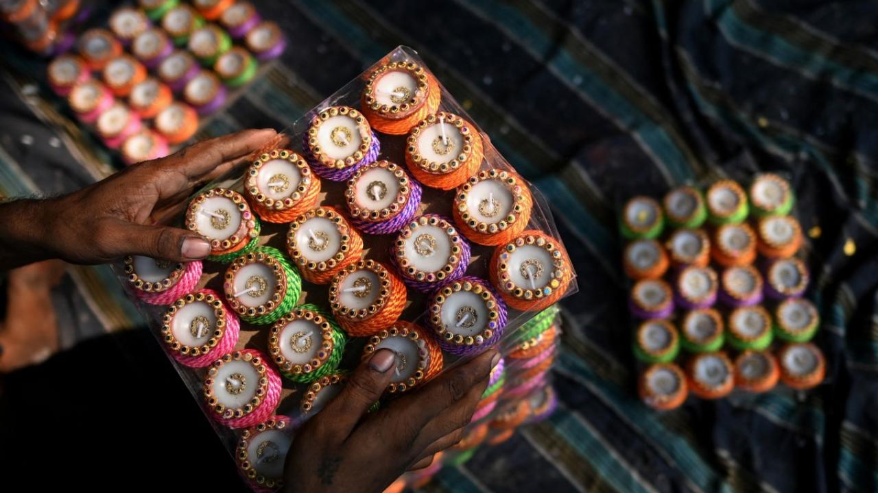 A potter packs diyas for sale at his workshop in New Delhi