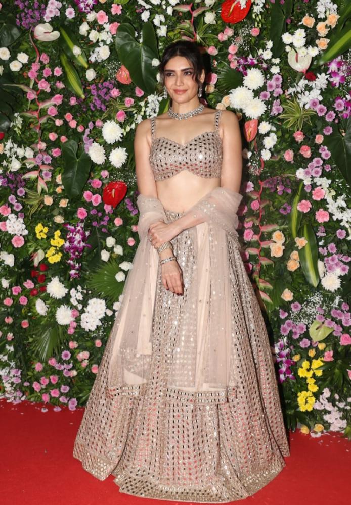 Karishma Tanna dazzled in a rose gold mirror-work lehenga. A dupatta added a graceful touch to her outfit. 