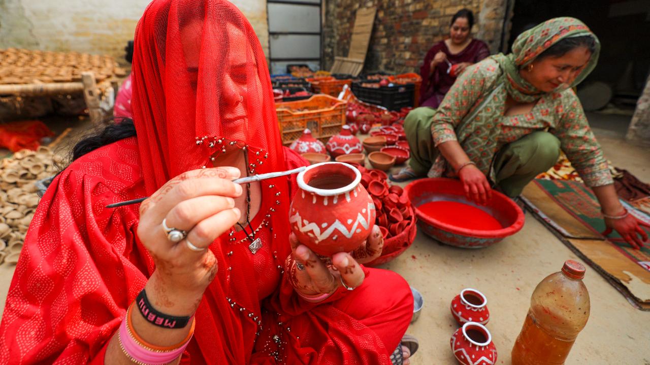 Women in border villages and members of 'Nari shakti' self-help groups under UMEED scheme make earthern lamps and diyas ahead of Diwali at a village near the border in Jammu
