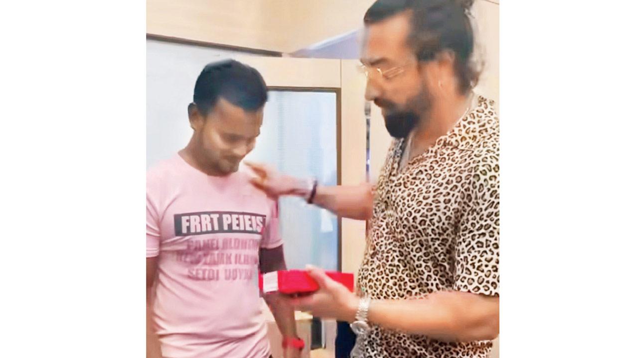 Actor Ajaz Khan gifting a mobile phone to his peon Suraj Gaud