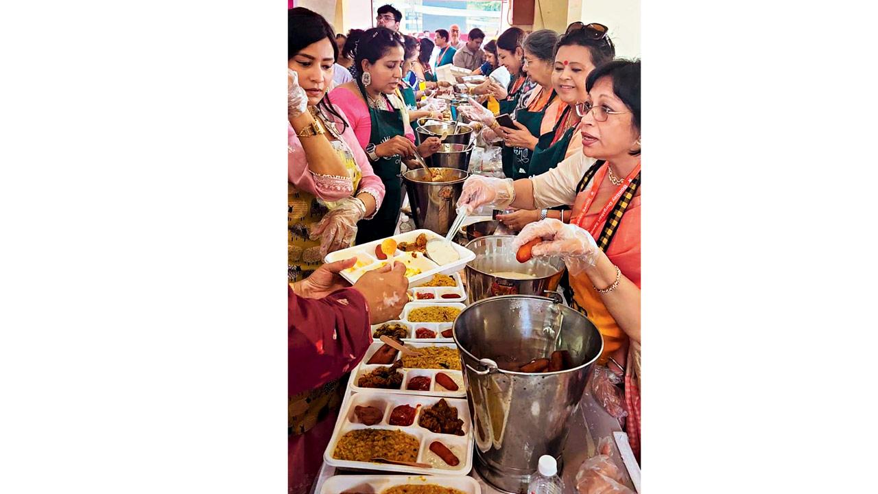 Bombay Durgabari Samiti members distributing bhog at Kemps Corner last year