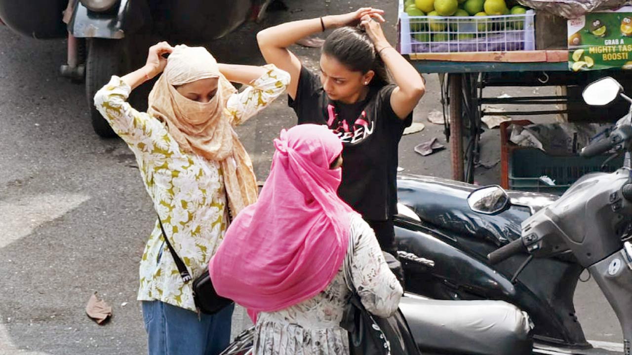 Women trying to protect themselves from the heat in Bandra on Thursday. Pic/Sayyed Sameer Abedi
