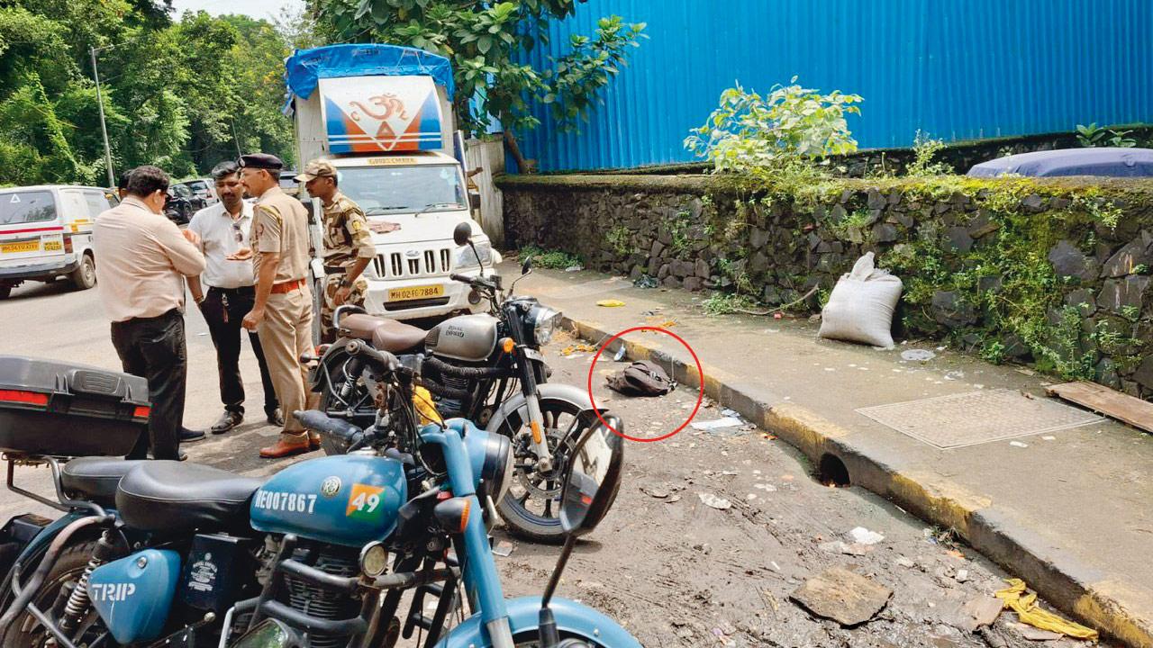 Officials found a black bag (circled in picture) containing a 7.62 mm bore pistol near the crime scene