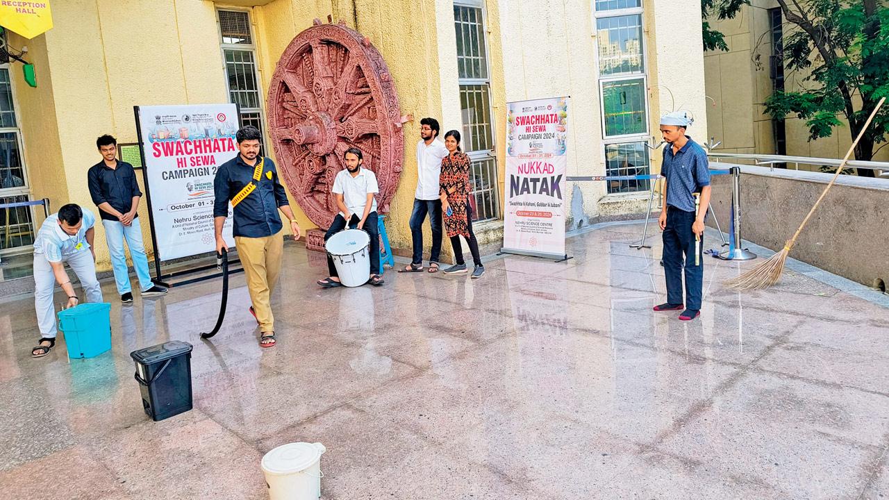 A moment from the skit, where Gabbar makes a dramatic entry with his belt, as his men line up dustbins for different kinds of waste