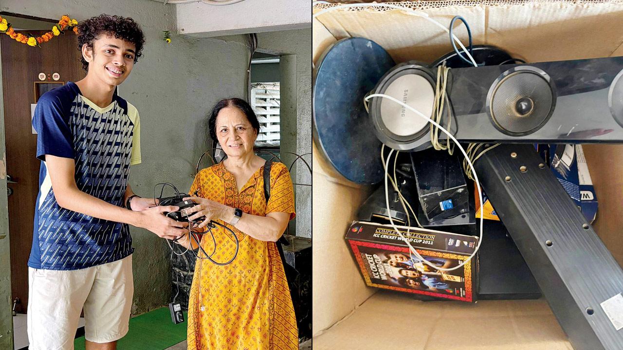 A woman hands over e-waste to a student (right) a pile of e-waste