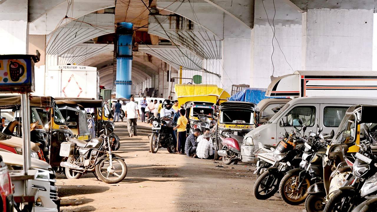 Illegal garages operate in the space below this flyover where vehicles are also parked. Pics/Ashish Raje