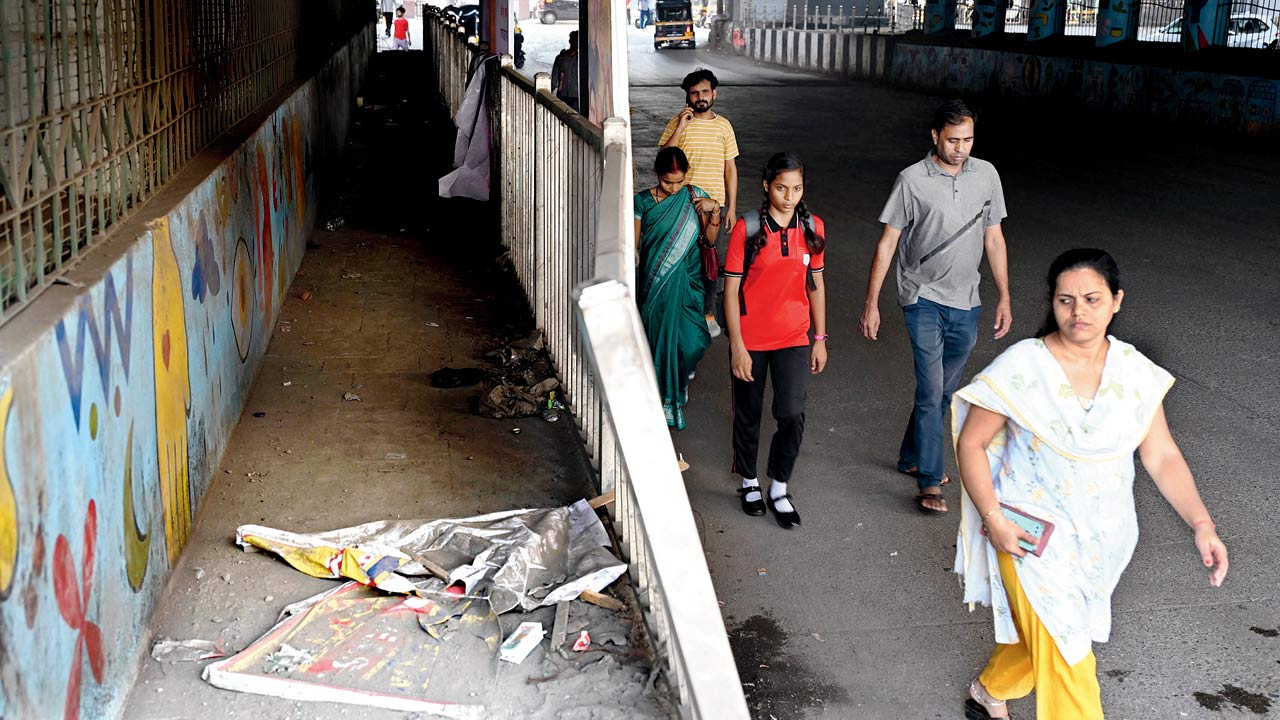 Pedestrians steer clear of the narrow footpath under the Pathanwadi-Dindoshi flyover. PICS/NIMESH Dave