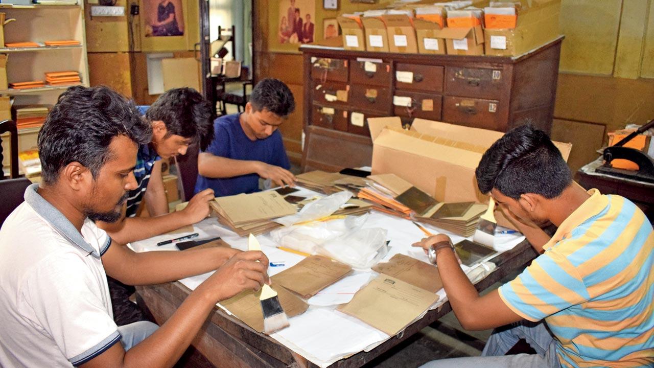 Volunteers work on the preservation process