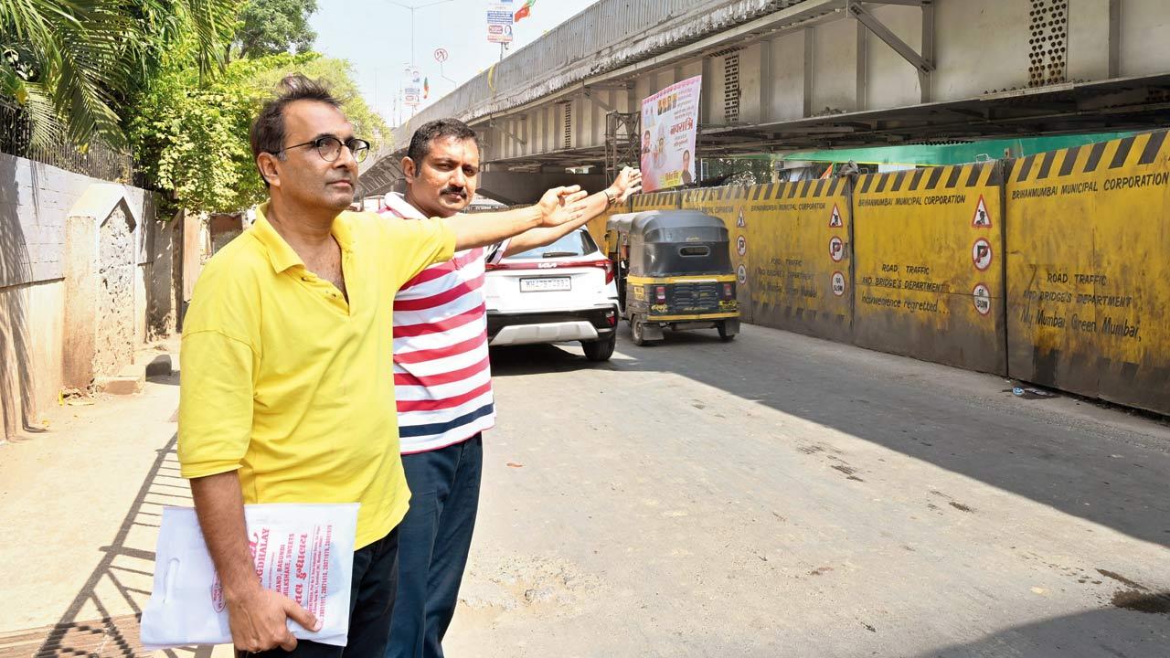 Gautam Dalal (right) and Sushant Saha, members of Girdhar Park Association, point to the constricted road because of the flyover. Pic/Nimesh Dave