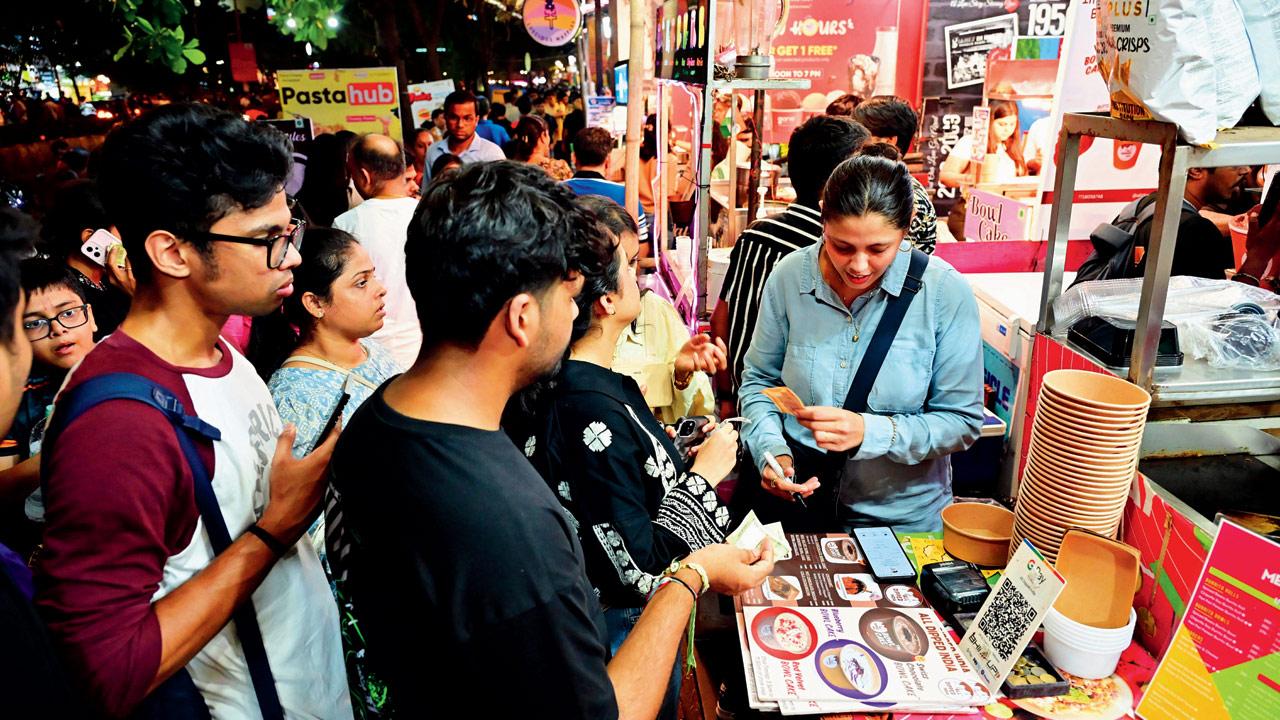 Patrons gather around the stall to grab their own bowl cakes