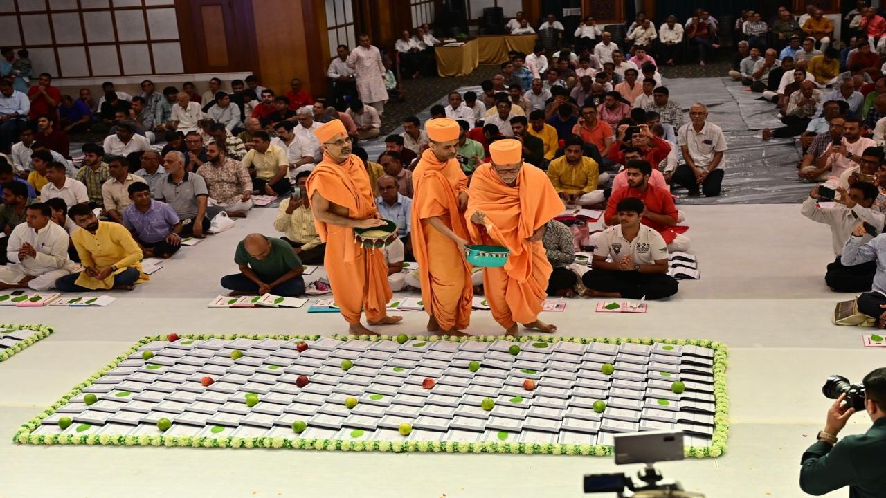 Priests sprinkle flower petals on chopda (accounting books) at Swaminarayan Temple, Dadar 