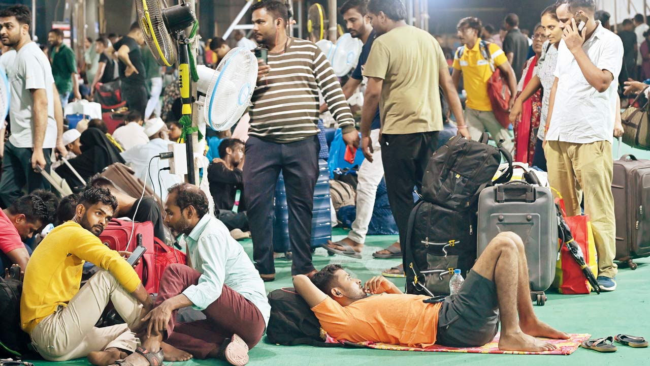Scores of passengers kill time before their train arrives in the waiting area of LTT on Tuesday. Pic/Atul Kamble