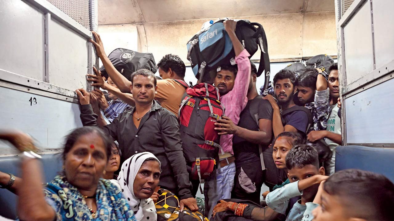 Unreserved travellers jostle for space in the compartment amid suffocating conditions. Pic/Ashish Raje