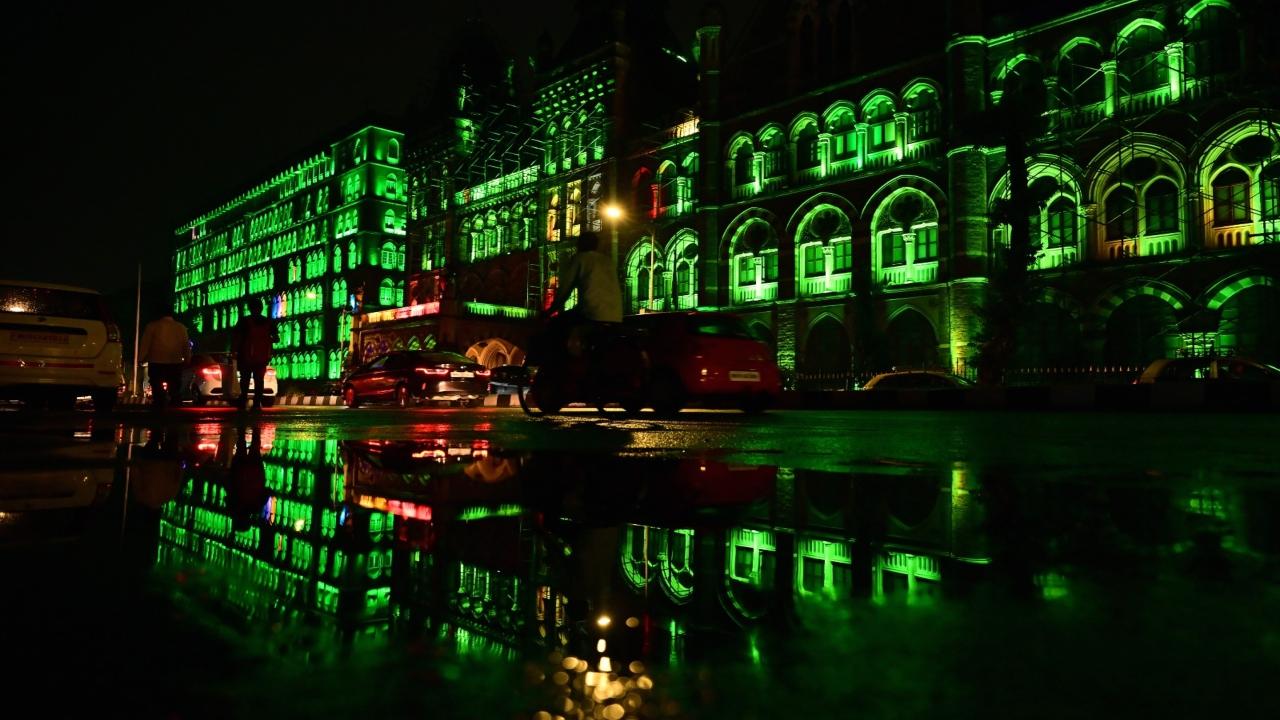 The reflection of a BMC building is seen in a puddle of rain water after south Mumbai received moderate rainfall on Sunday evening