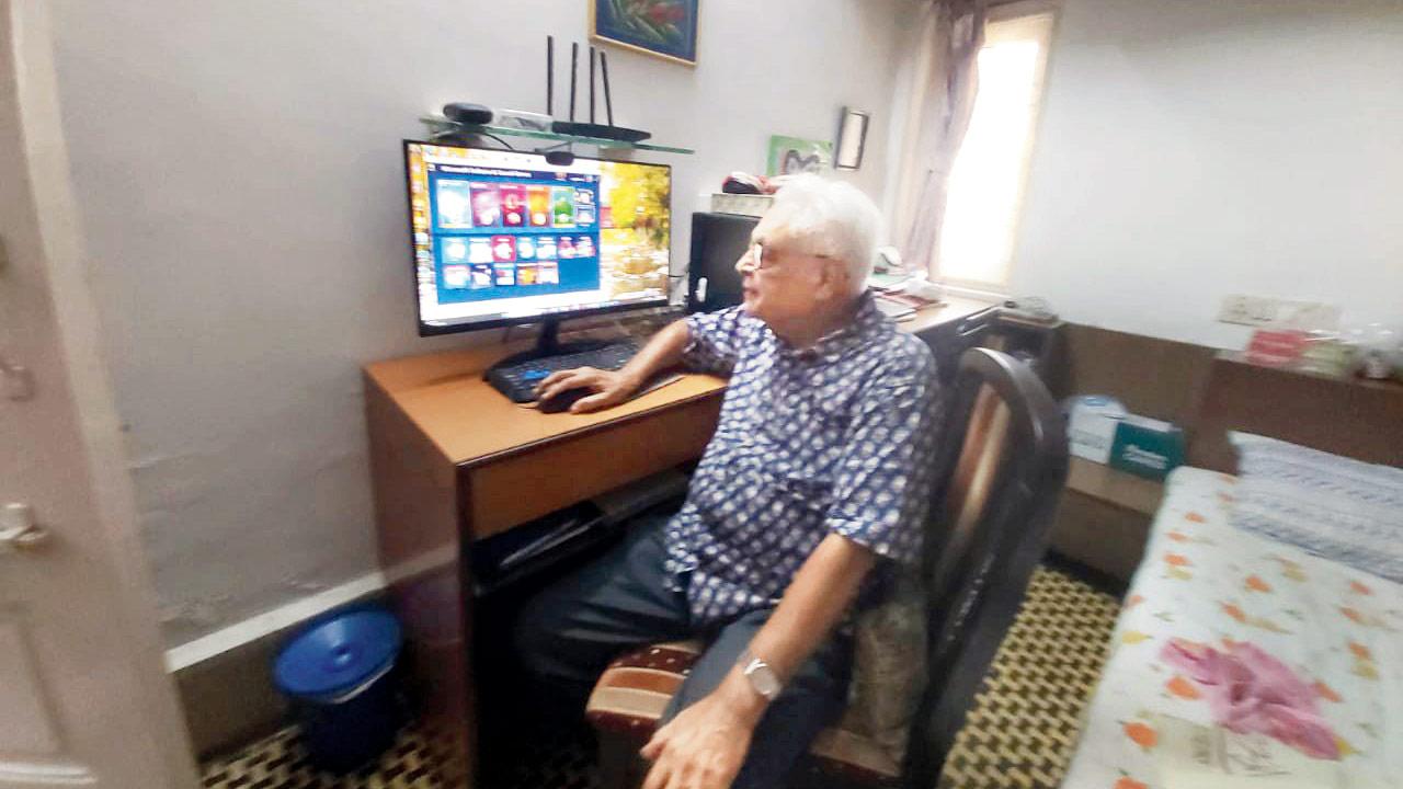 Rajnikumar Shah plays a card game on his computer