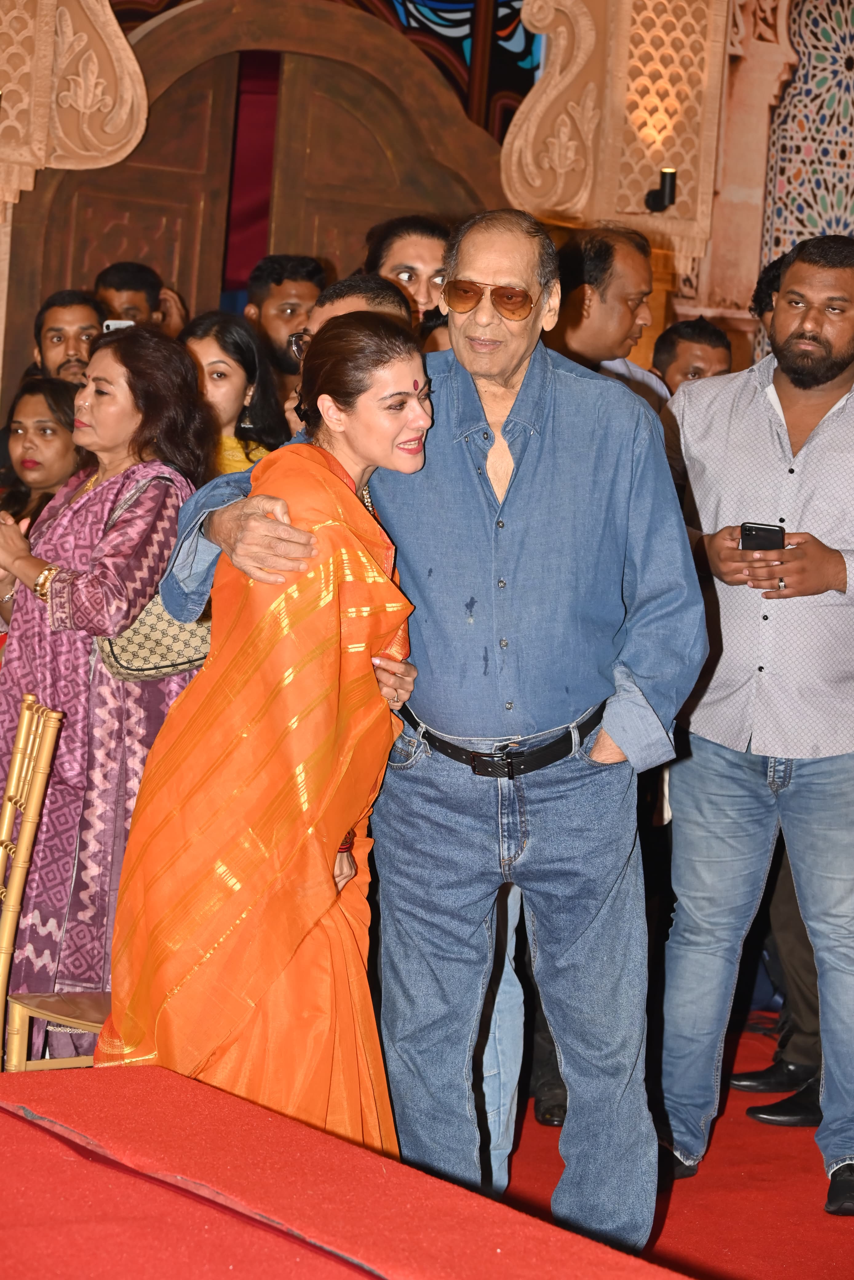 The actress paired her stunning saree with a red strappy blouse. With a subtle makeup look, a big bindi on her forehead, and her hair tied back in a chic bun, Kajol looked super cute.