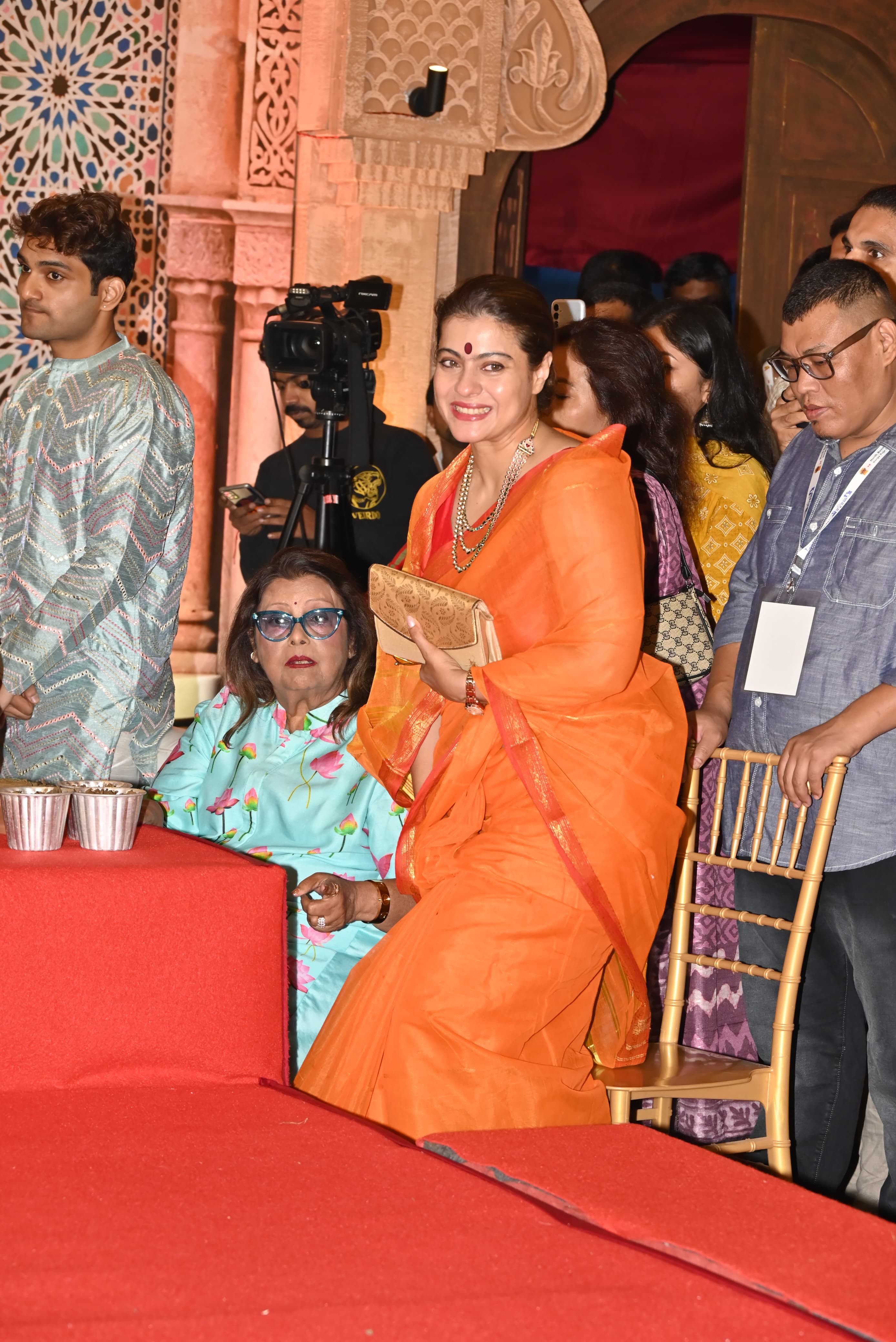 Meanwhile, Kajol stunned at the Puja Pandal in an orange saree that featured a red border