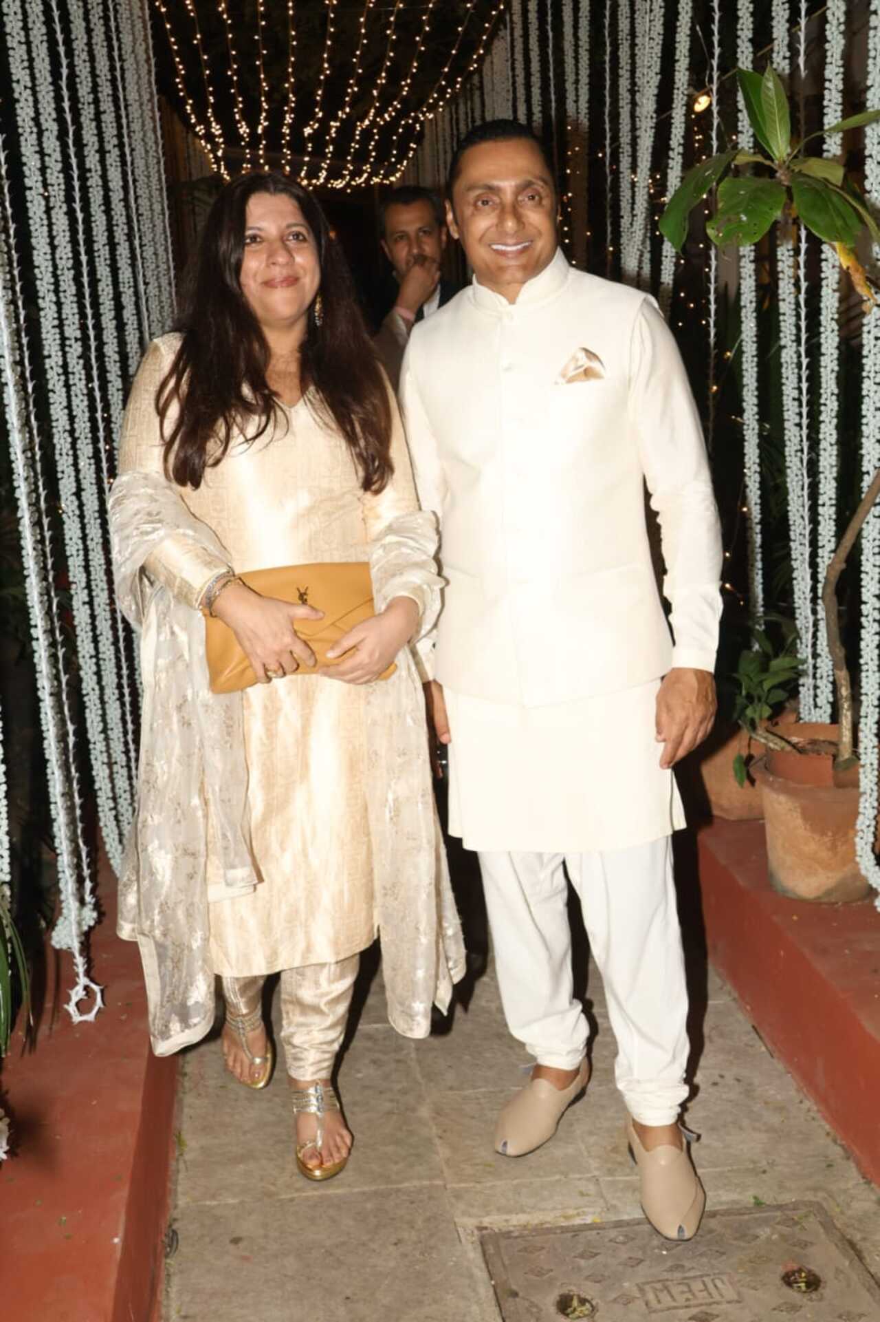 Zoya Akhtar poses with Rahul Bose for the paparazzi as they arrive for the party