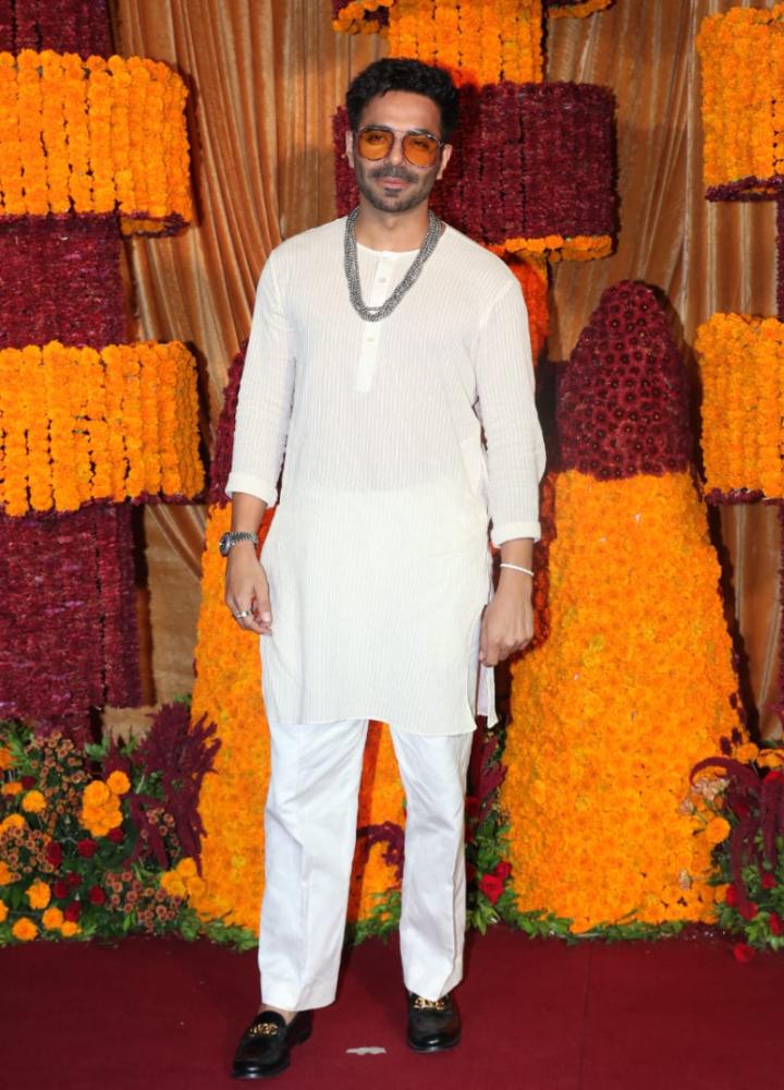 Aparshakti Khurana kept it simple with a plain white kurta pyjama. A shimmering silver neckpiece completed the look.