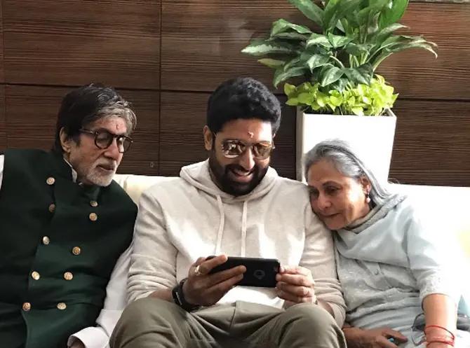 Abhishek Bachchan shows his new phone to his parents Amitabh and Jaya Bachchan.