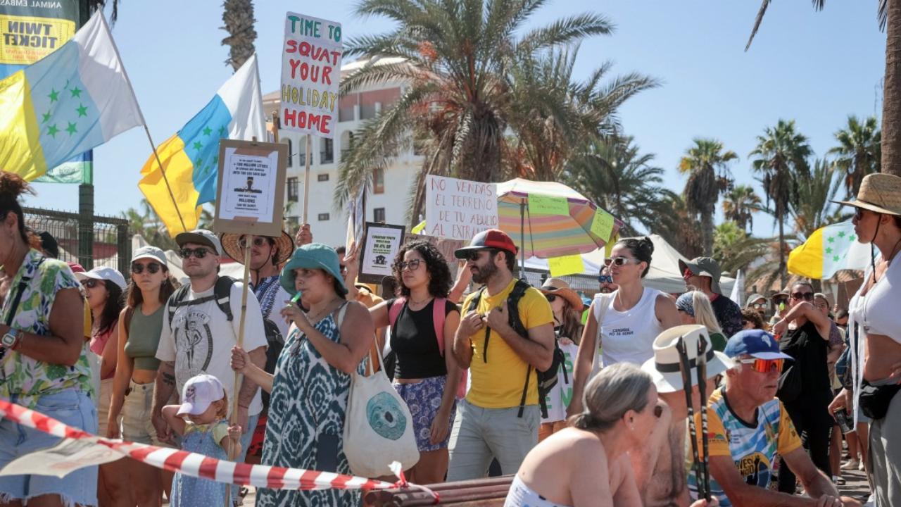 Holding placards reading 