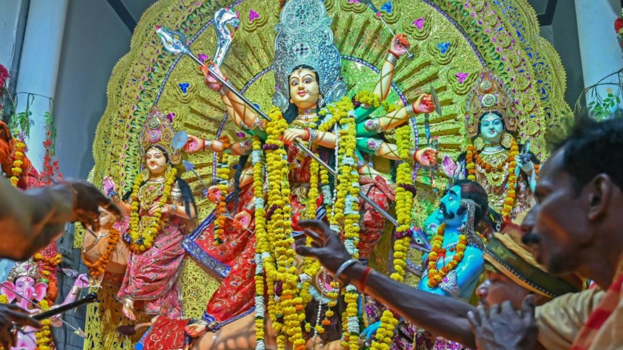 Hindu priests perform 'Havan' or a religious ritual in front of an idol of the goddess Durga during the Durga Puja festival in Amritsar 