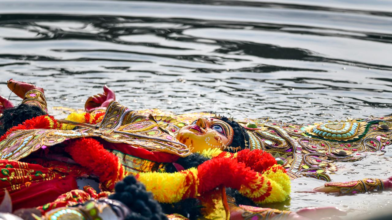 An idol of Goddess Durga being immersed during visarjan marking the end of the Durga Puja festival at Dharmanagar area in North Tripura district