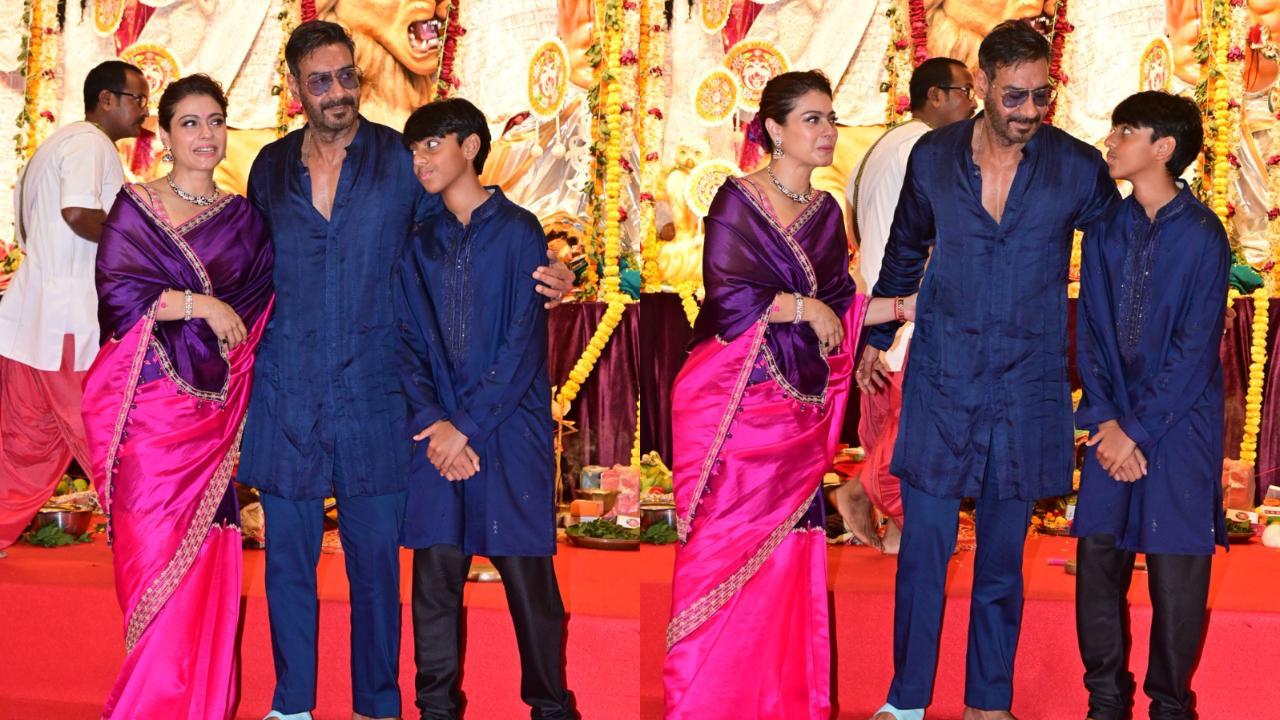 Kajol pinches Ajay Devgn for THIS reason as they click family picture at Durga puja pandal, watch 