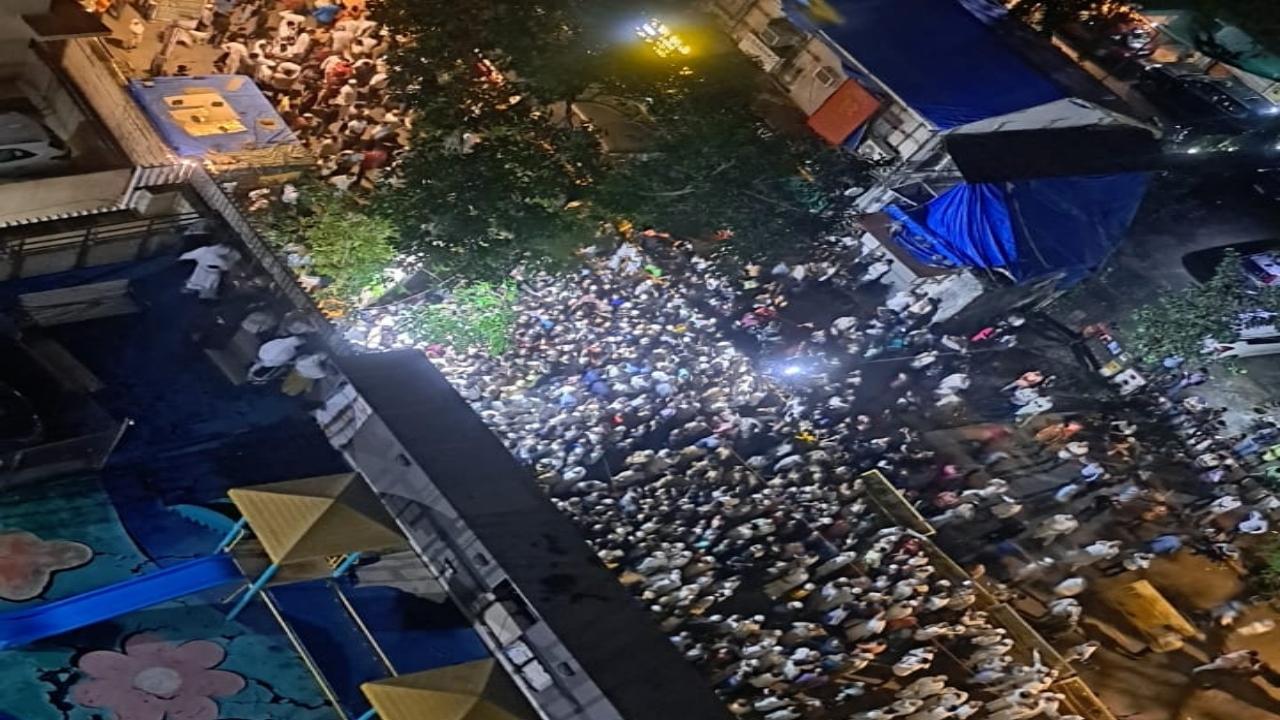 Locals gather for the funeral namaaz outside Baba Siddique's residence. A large crowd had offered prayers in the building compound, and two floors of the parking of the building 