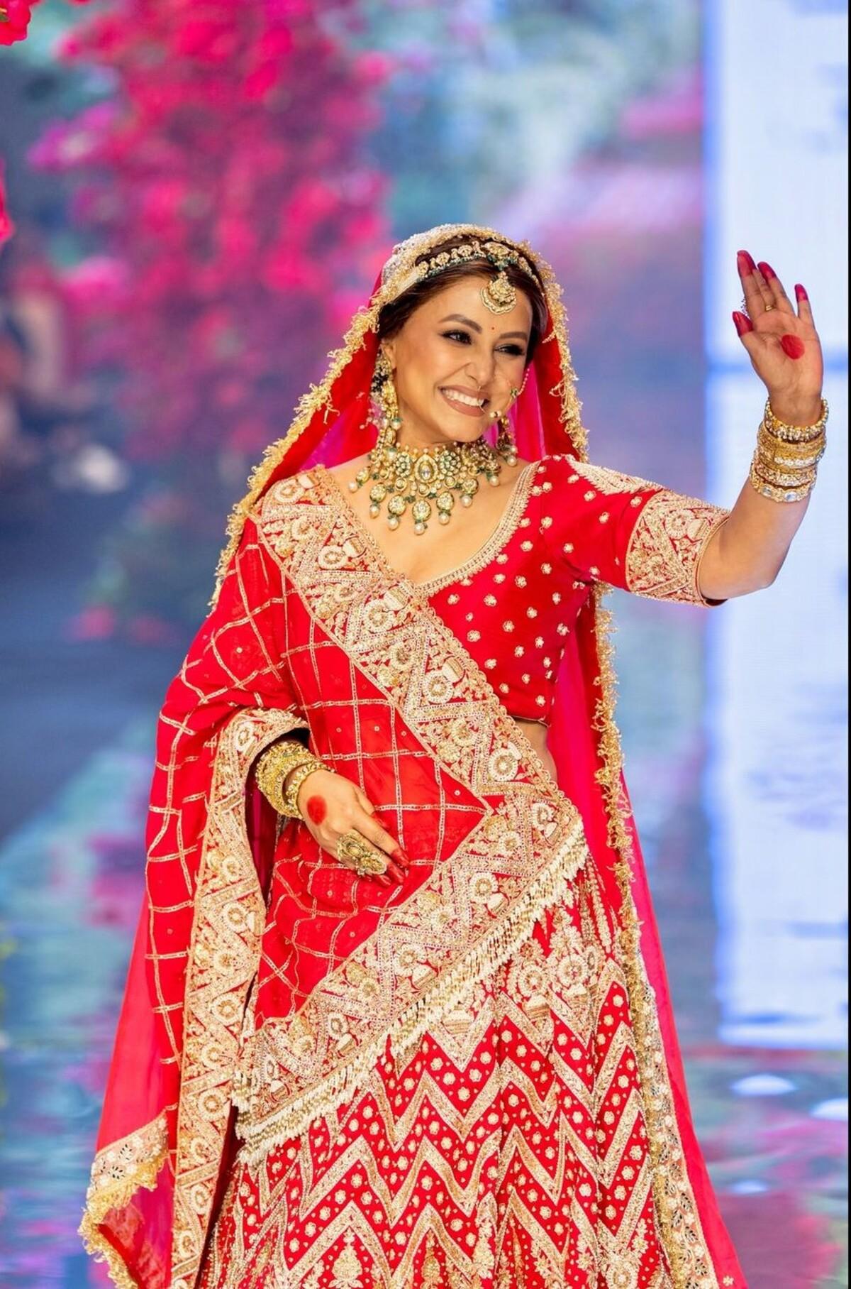 Hina dressed up as a bride and she donned a beautiful hand-embroidered red bridal lehenga from the collection 'Sajni' at a fashion show