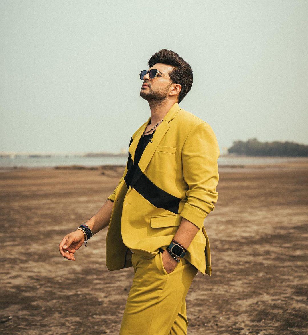 With stylish glairs and a side bag, the combination brought a stylish contrast, giving him a striking and polished appearance.