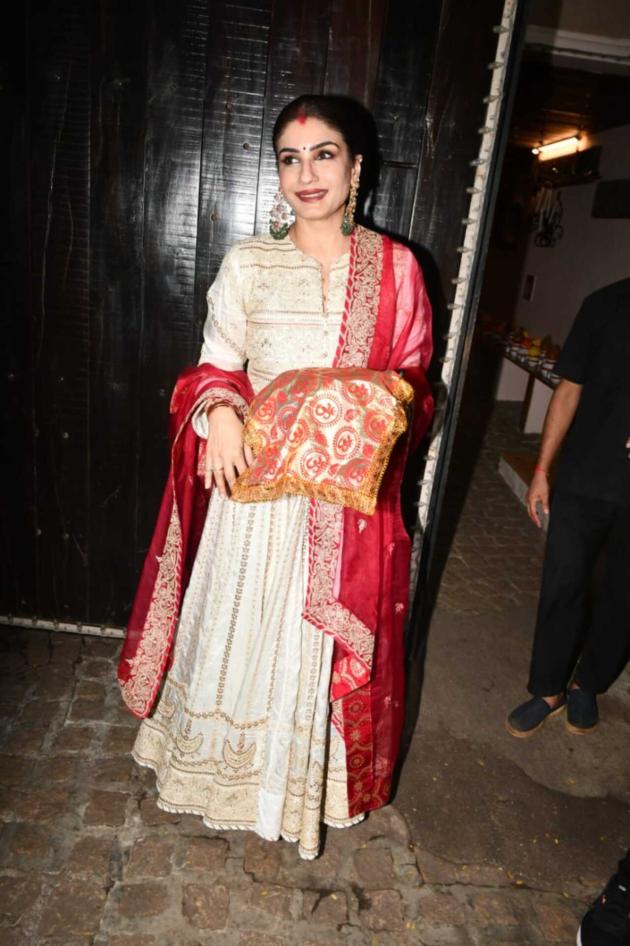 Raveena Tandon donned a beige anarkali suit with a red dupatta.